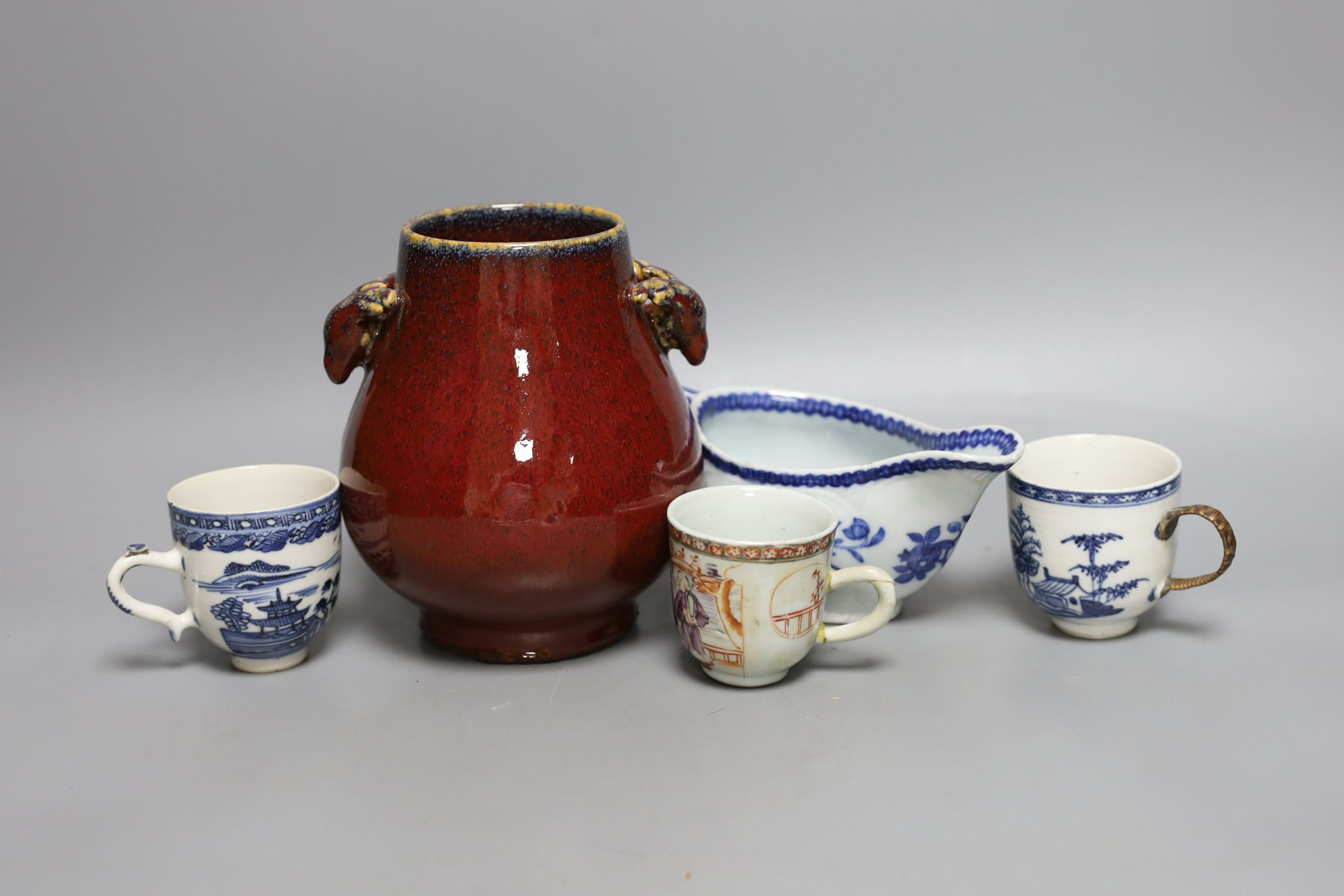 An 18th century Chinese export tea cup, 3 pieces of export blue and white and a sang de boeuf vase. Tallest 16cm